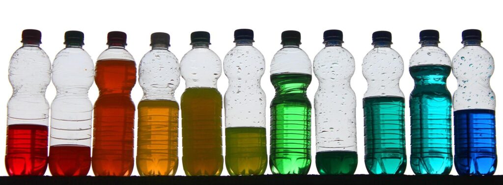 Various bottles of different coloured liquid with no labels.